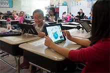 Children in classroom using tablets
